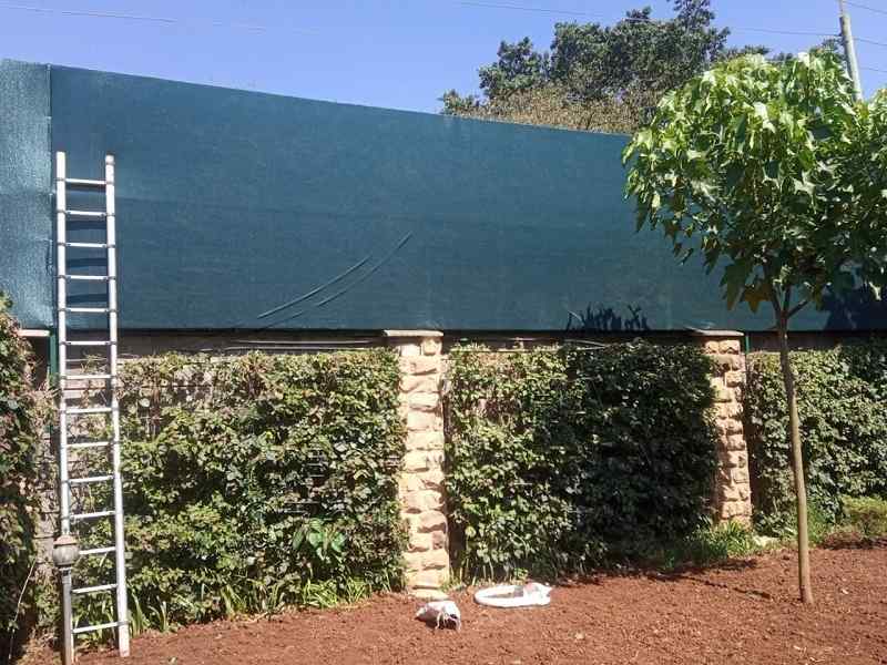 Breathable screen fabric used as a modern outdoor fence
